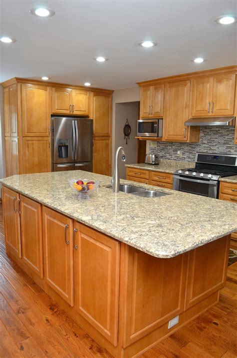 honey maple cabinets with stainless steel and blue pearl granite|honey maple cabinet lighting.